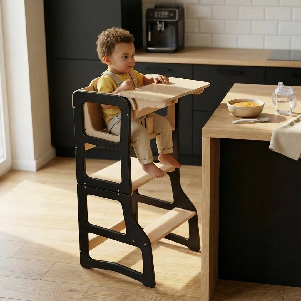 Child sitting in a high chair at a kitchen island with a view of a coffee maker and fruit bowl.