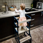 Child on a step stool in a kitchen