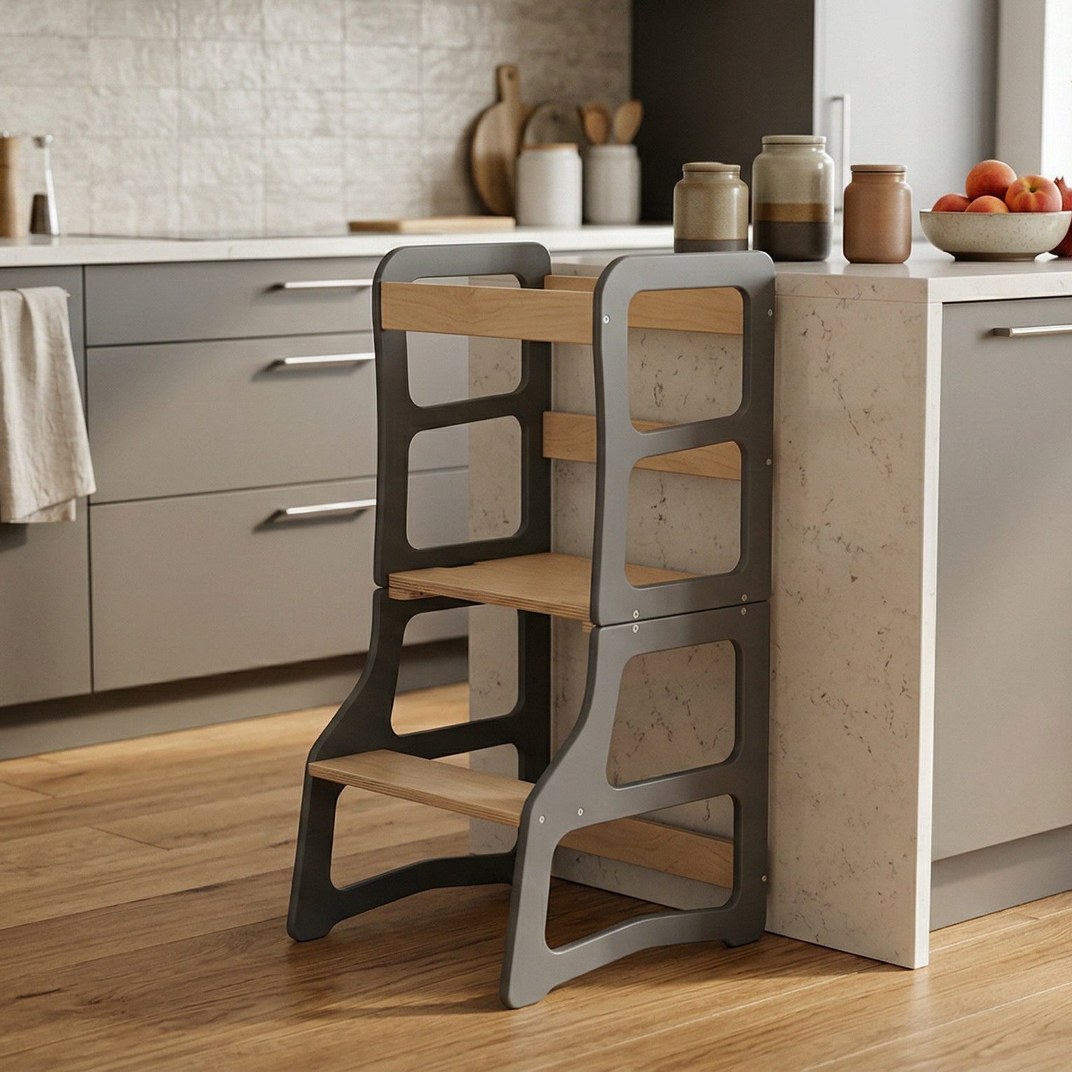 Wooden step stool in a modern kitchen setting with gray cabinets and a white countertop.